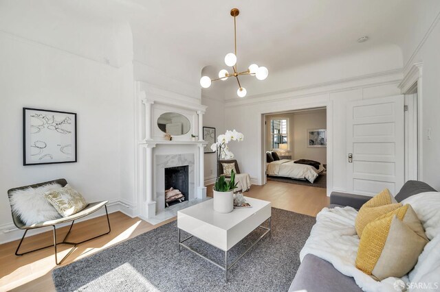 289 Church St, San Francisco, CA 94114 - living area with wood finished floors, a chandelier, a fireplace, and crown molding