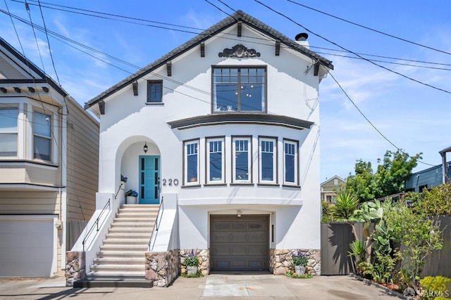 220 Delano Ave, San Francisco, CA 94112 - view of front facade featuring stucco siding, a garage, concrete driveway, and stone siding