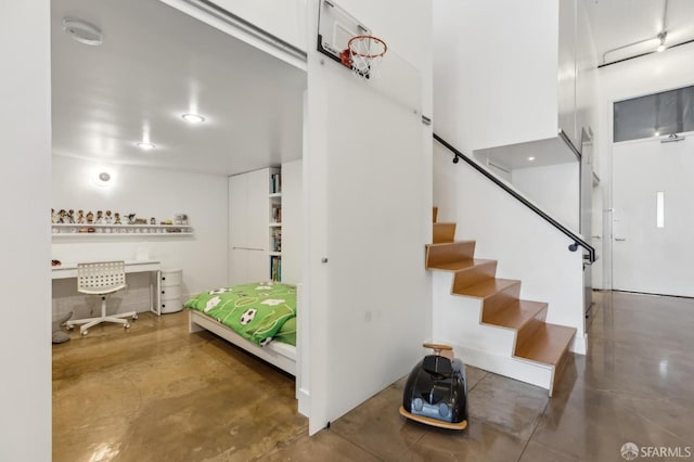 stairs with concrete flooring