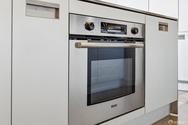 room details featuring white cabinetry and oven