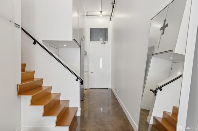 staircase with concrete floors