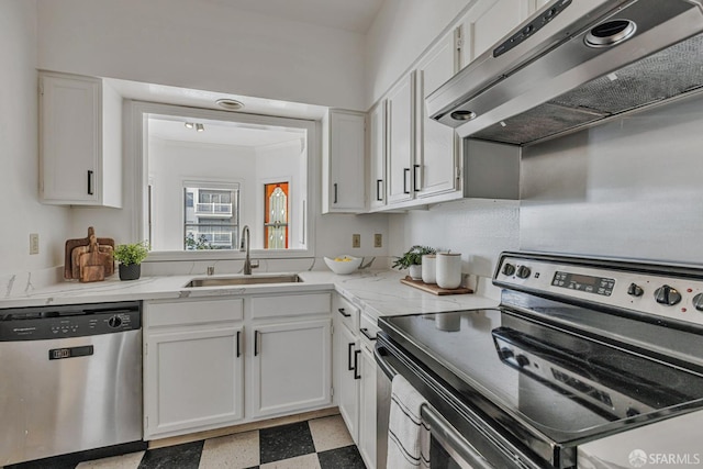 605 Carolina St, San Francisco, CA 94107 - kitchen featuring appliances with stainless steel finishes, exhaust hood, white cabinets, and light flooring