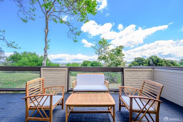 wooden deck with an outdoor living space
