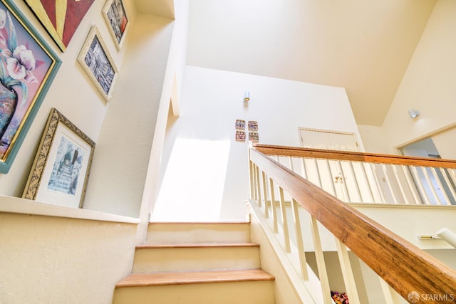 stairway with vaulted ceiling
