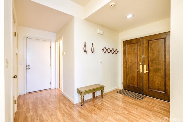 foyer entrance featuring light wood-type flooring and baseboards