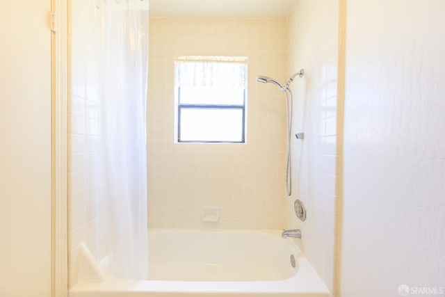 bathroom with shower / bath combo with shower curtain