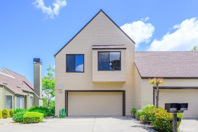 view of front of property featuring a garage and concrete driveway