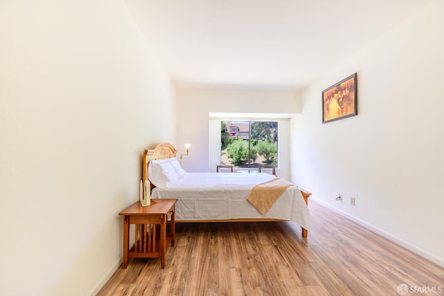 bedroom with light wood-style floors and baseboards