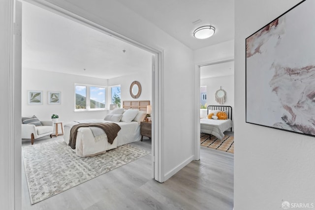 bedroom with wood finished floors and baseboards