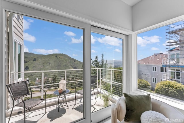 sunroom / solarium featuring a mountain view