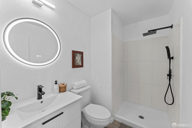 bathroom with toilet, a walk in shower, and vanity