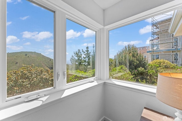 unfurnished sunroom with a mountain view