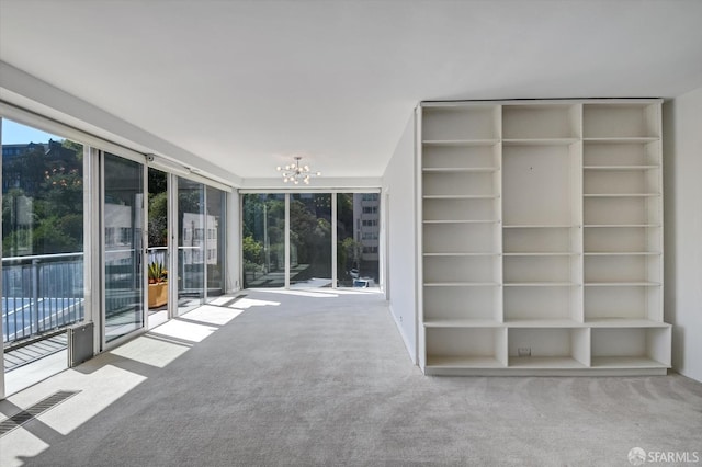 interior space featuring carpet and an inviting chandelier