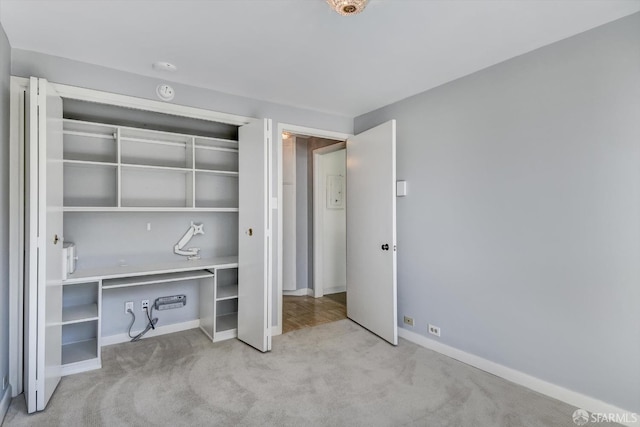 unfurnished bedroom featuring light carpet