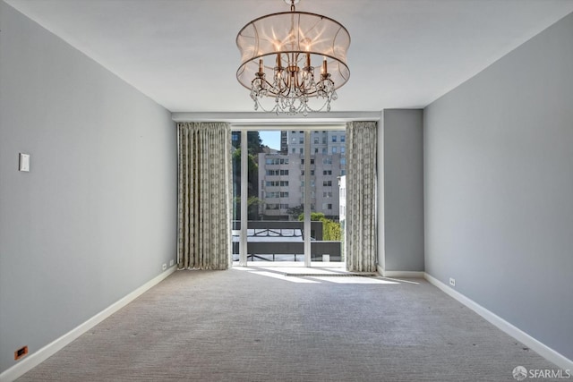 empty room with an inviting chandelier and carpet