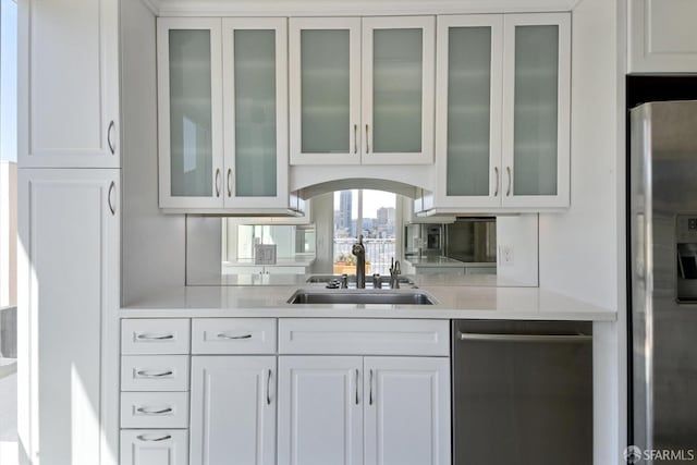 bar with white cabinets, sink, and stainless steel appliances