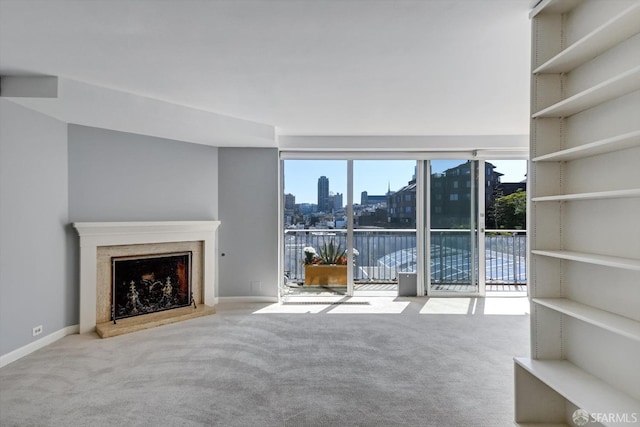 unfurnished living room with light colored carpet and a premium fireplace