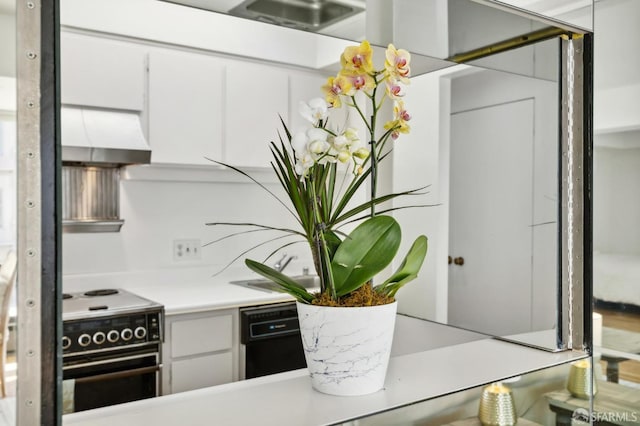 kitchen featuring white cabinets, black dishwasher, wall chimney exhaust hood, and electric stove