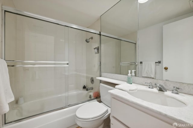 full bathroom with vanity, toilet, and shower / bath combination with glass door