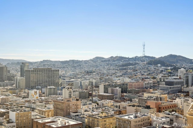 property's view of city featuring a mountain view