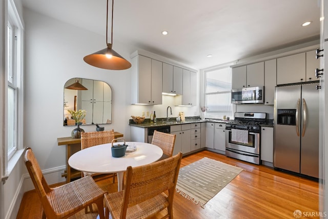 1630 Clay St Unit 4, San Francisco, CA 94109 - kitchen featuring appliances with stainless steel finishes, dark countertops, gray cabinets, light wood-style floors, and recessed lighting