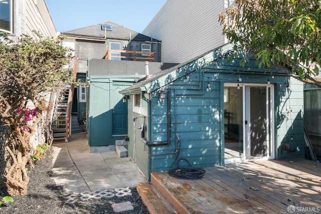 back of property featuring a deck and stairway