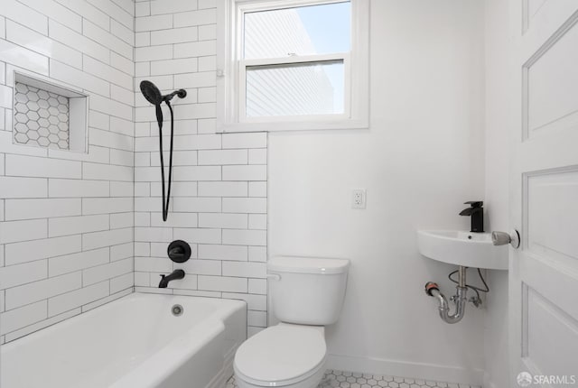 bathroom with baseboards, toilet, and shower / bathtub combination