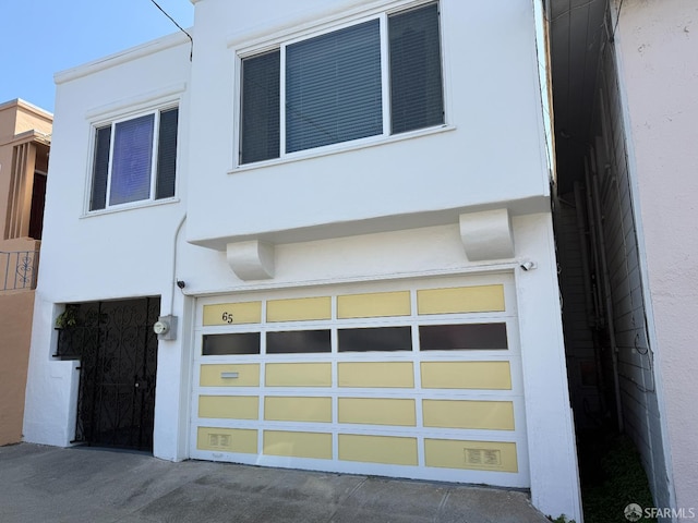 65 Neptune St, San Francisco, CA 94124 - view of front of property with stucco siding and a garage