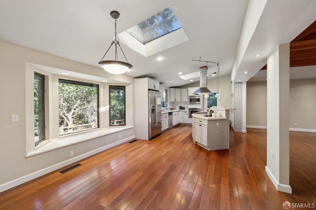 kitchen with decorative light fixtures, a center island, appliances with stainless steel finishes, island exhaust hood, and white cabinets