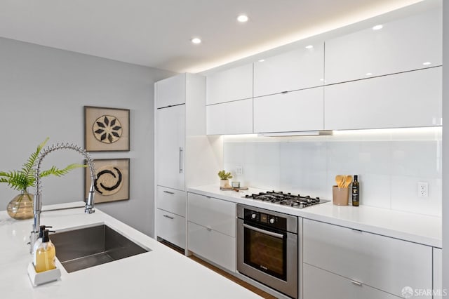 kitchen with white cabinetry, sink, and stainless steel appliances