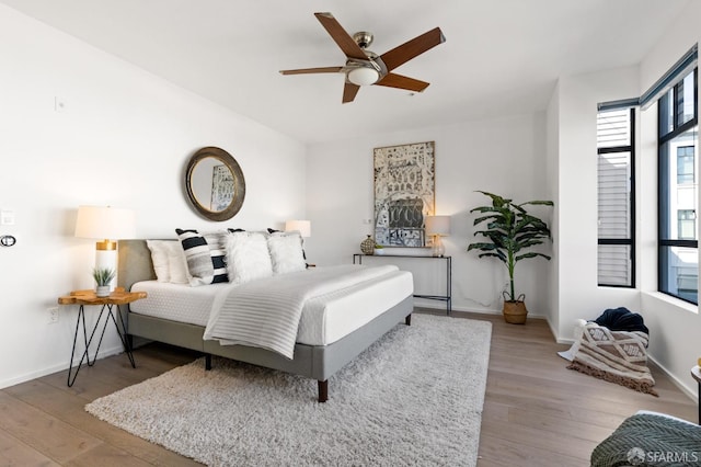 bedroom with light hardwood / wood-style flooring and ceiling fan