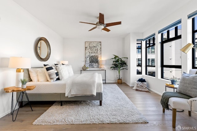 bedroom featuring hardwood / wood-style floors and ceiling fan