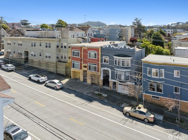 view of building exterior with a residential view and uncovered parking