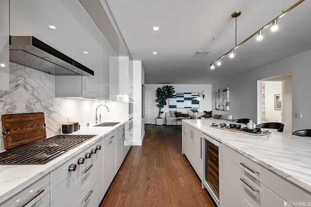 kitchen with white cabinetry, sink, beverage cooler, dark hardwood / wood-style floors, and decorative backsplash