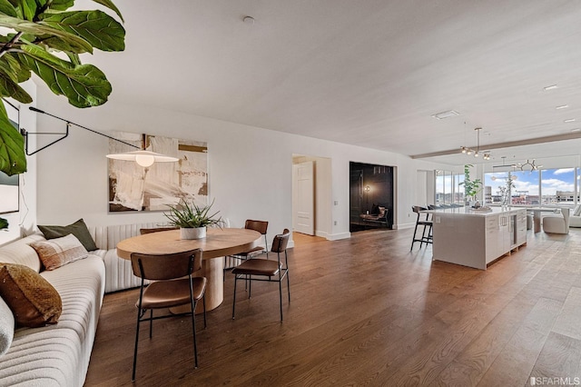 dining space featuring hardwood / wood-style floors and a notable chandelier