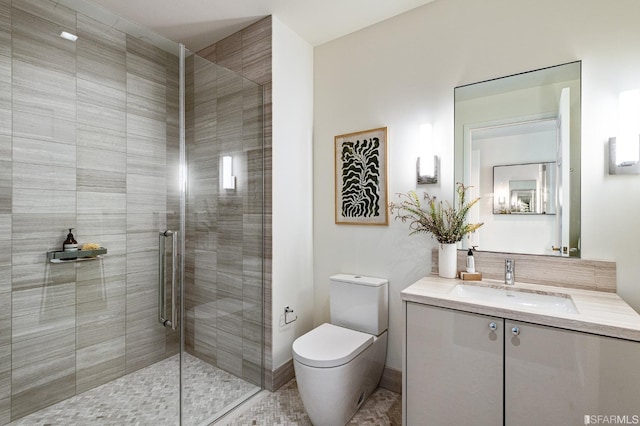 bathroom with an enclosed shower, vanity, toilet, and tile patterned flooring