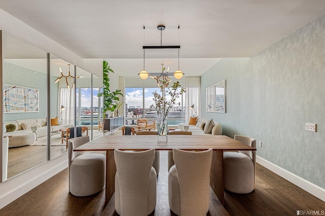 dining room featuring dark hardwood / wood-style flooring and a notable chandelier