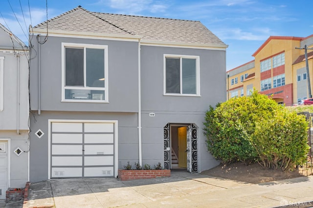 141 Cambridge St, San Francisco, CA 94134 - view of front of house featuring stucco siding, an attached garage, and driveway