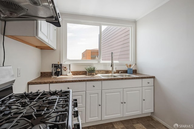 141 Cambridge St, San Francisco, CA 94134 - kitchen with a sink, white cabinetry, dark countertops, stainless steel gas range, and ornamental molding
