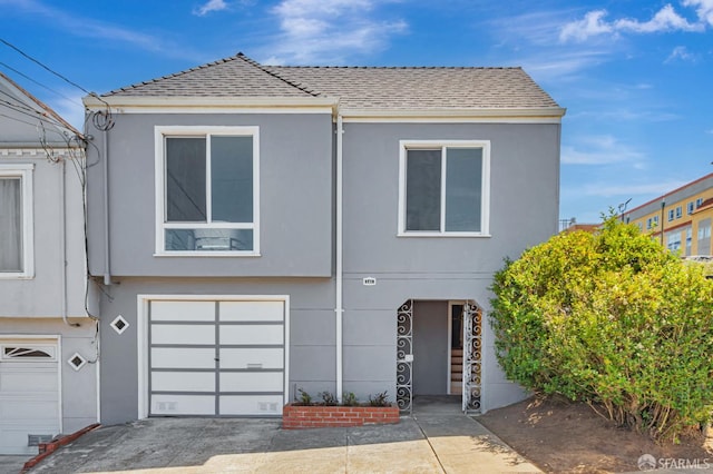 141 Cambridge St, San Francisco, CA 94134 - view of front facade with stucco siding, a shingled roof, and a garage