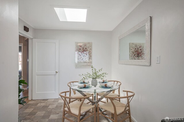141 Cambridge St, San Francisco, CA 94134 - dining area featuring a skylight and baseboards