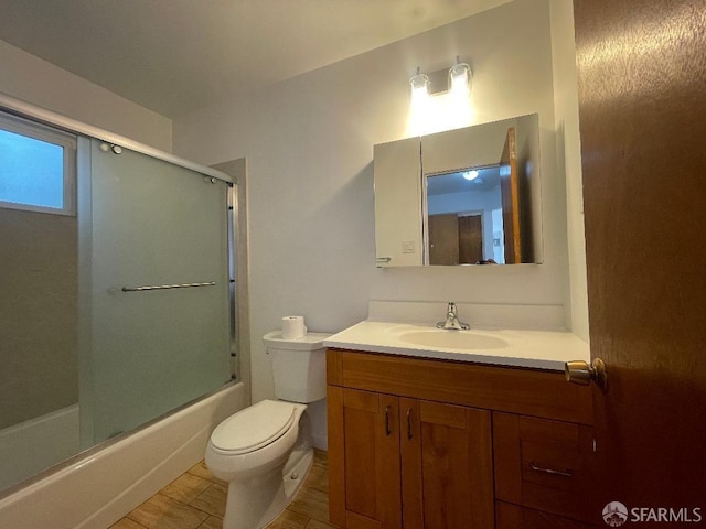 full bathroom with vanity, toilet, enclosed tub / shower combo, and tile patterned floors