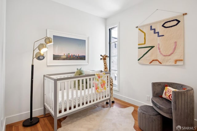 3445 Fillmore St, San Francisco, CA 94123 - bedroom featuring a nursery area and wood finished floors