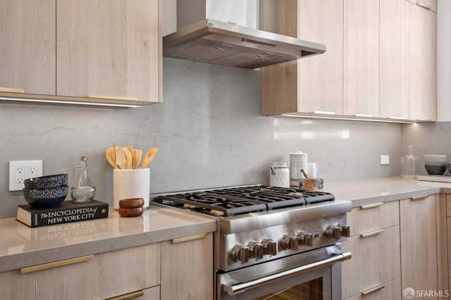3445 Fillmore St, San Francisco, CA 94123 - kitchen with wall chimney range hood, high end stainless steel range, light brown cabinets, and modern cabinets