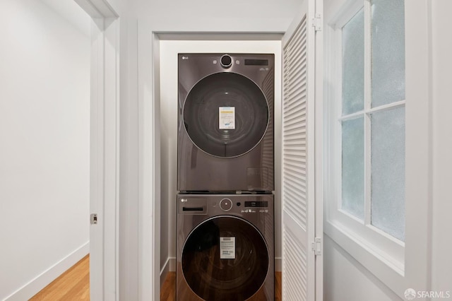 3445 Fillmore St, San Francisco, CA 94123 - washroom featuring stacked washing machine and dryer and wood finished floors