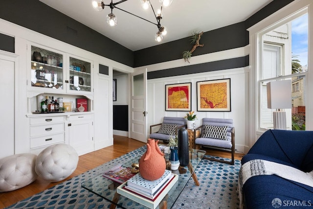 30 Lloyd St, San Francisco, CA 94117 - sitting room featuring wood finished floors, plenty of natural light, a chandelier, and a bar