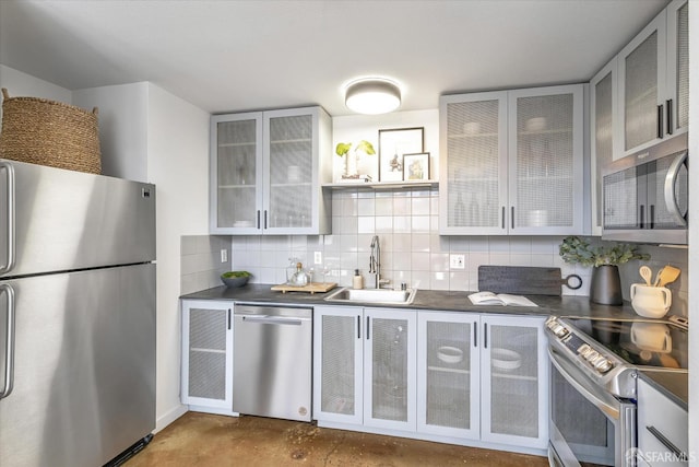 kitchen with sink, decorative backsplash, and stainless steel appliances