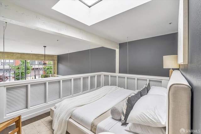 bedroom with beamed ceiling and a skylight