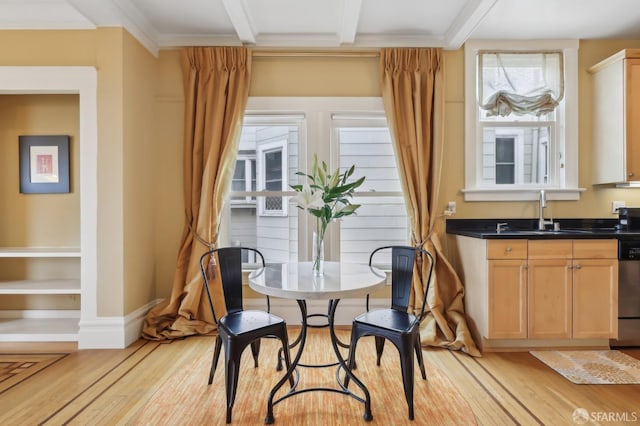 dining area with beamed ceiling, light wood-style flooring, and baseboards