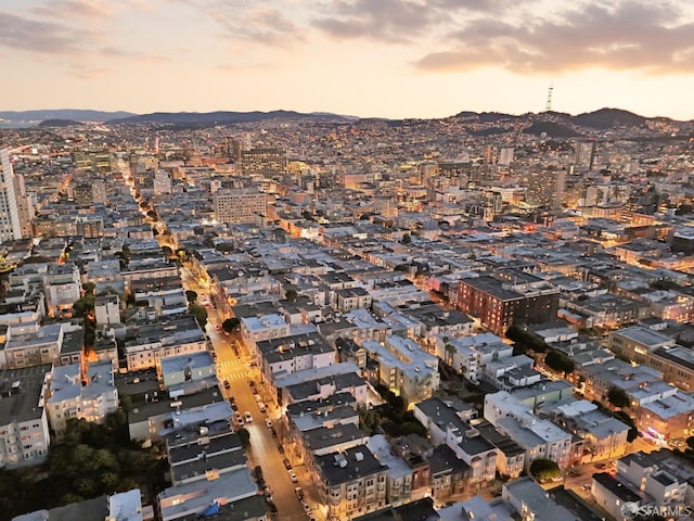 aerial view at dusk featuring a view of city